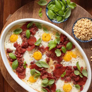 Overhead picture of Italian Polenta Breakfast Casserole in a white dish with toppings in small bowls