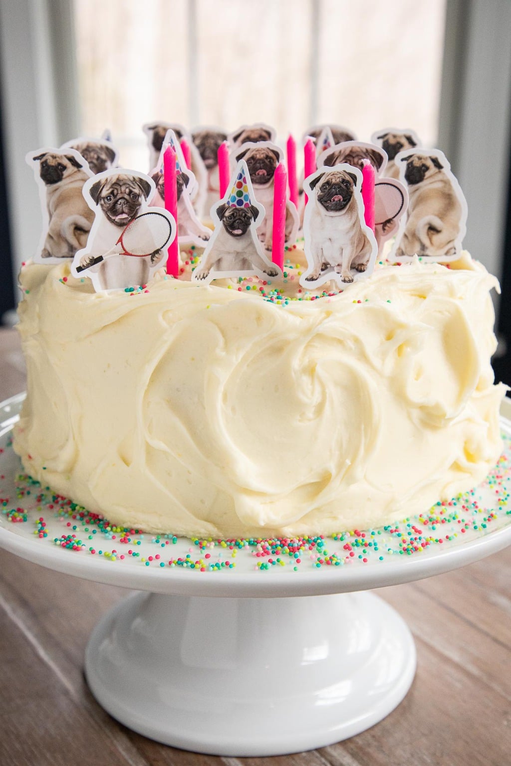 Photo of a Lemon Curd Poppy Seed Cake decorated for a "Pug" themed birthday party.
