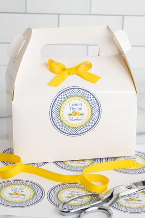 a box of Lemon Thyme Shortbread cookies with a yellow bow and custom label perfect for gifting