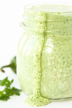 Vertical closeup photo of a jar of Light and Spicy Cilantro Dressing.