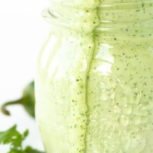 Vertical closeup photo of a jar of Light and Spicy Cilantro Dressing.
