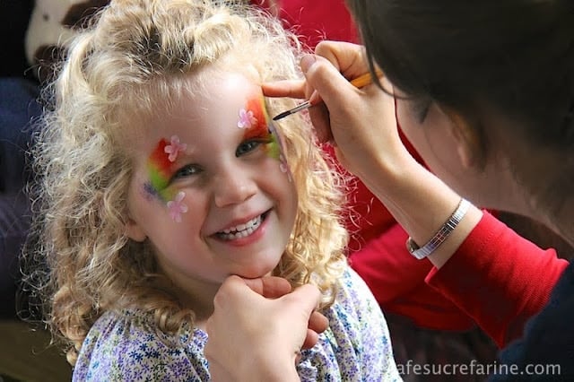 Lilly getting her face painted at the annual school fair in London, England.