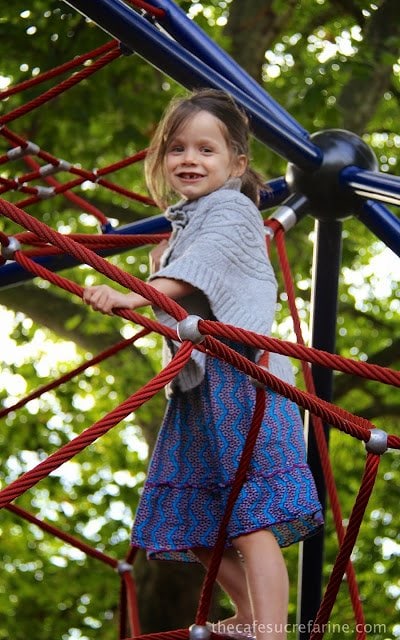 Elle on one of the many climbing apparatus at a playground in a London park.