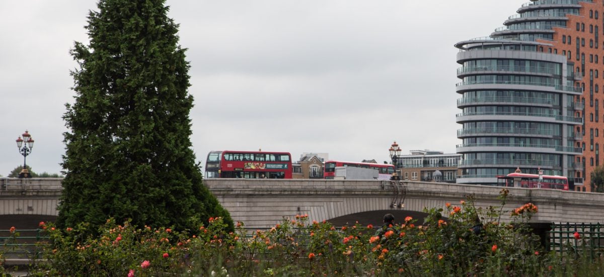 Photo of red London transportation buses passing over Putney Bridge, London, UK.