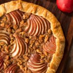 Overhead picture of Maple-Glazed Red Pear Galette on a wooden cutting board