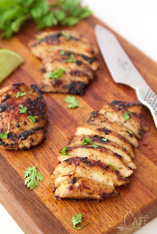 Photo of sliced Mexican Honey-Lime Grilled Chicken on a maple cutting board.