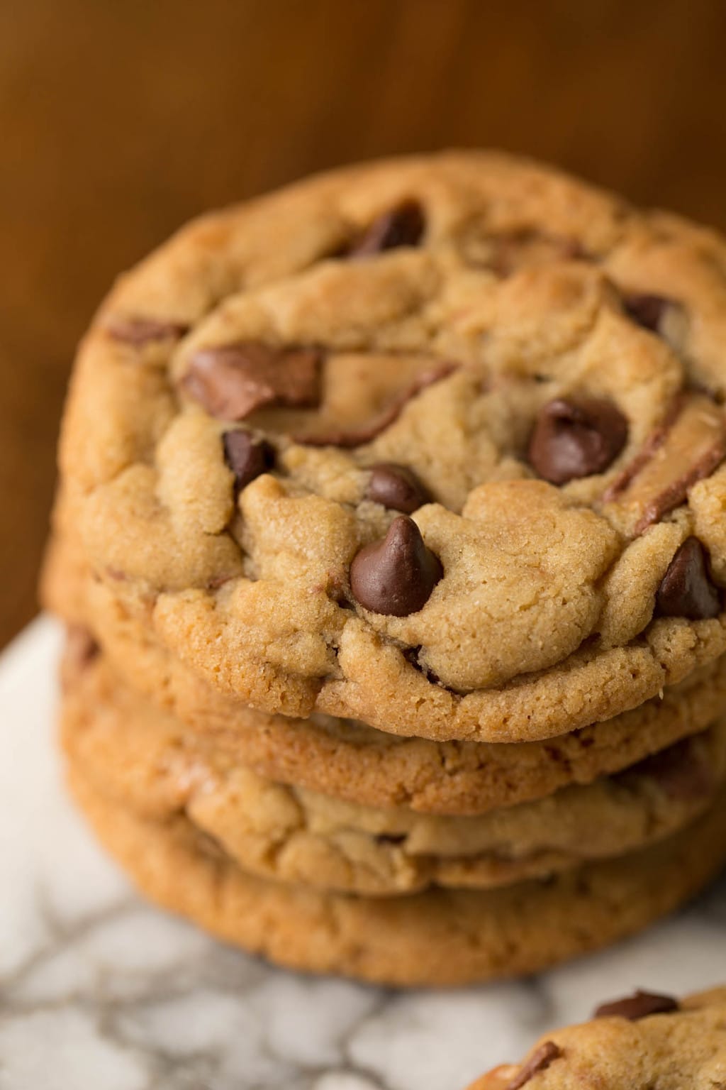 Overhead closeup of a stack of One Bowl Toffee Bar Chocolate Chip Cookies on a marble slab.