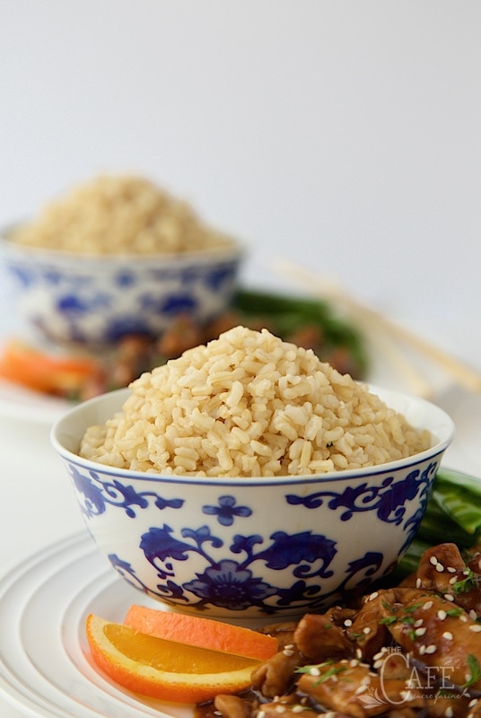 Easy Orange Chicken with Brown Rice - a super delicious dinner you can have on the table in no time flat. A few secret ingredients make the chicken incredibly tender! thecafesucrefarine.com