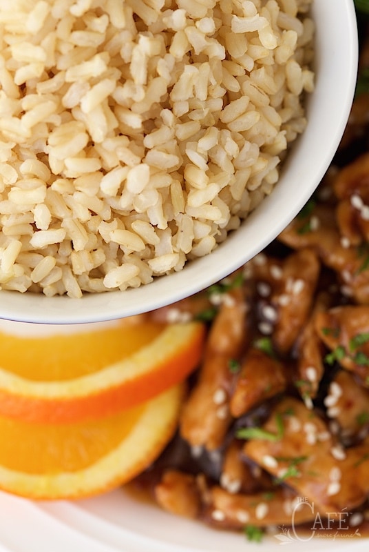 Easy Orange Chicken with Brown Rice - a super delicious dinner you can have on the table in no time flat. A few secret ingredients make the chicken incredibly tender! thecafesucrefarine.com