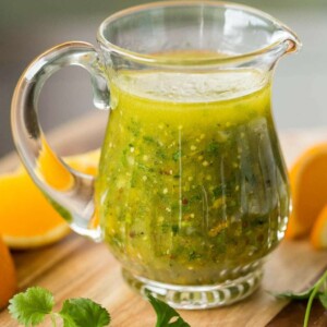 Vertical picture of Orange Cilantro Vinaigrette in a glass cruet