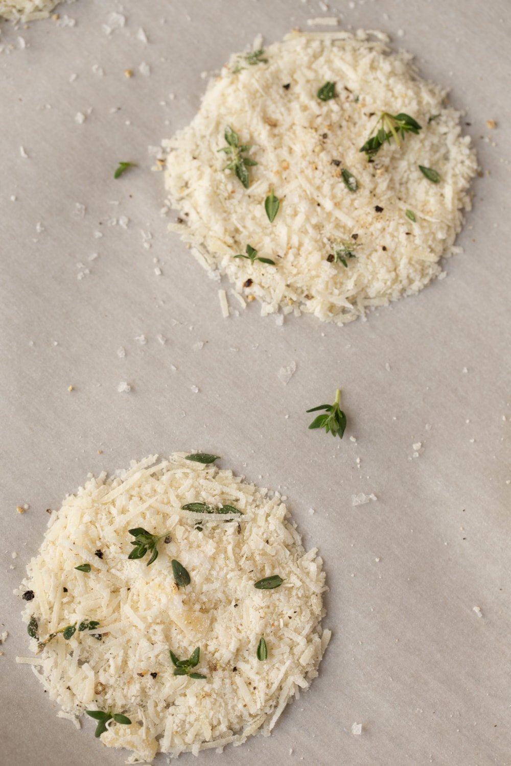 Parmesan Crisps with Thyme and Sea Salt - one of the most elegant (and easy!) Italian-inspired appetizers you'll ever have the pleasure of meeting. A delicious little bite to go with cocktails, on salads or as a soup topping. thecafesucrefarine.com