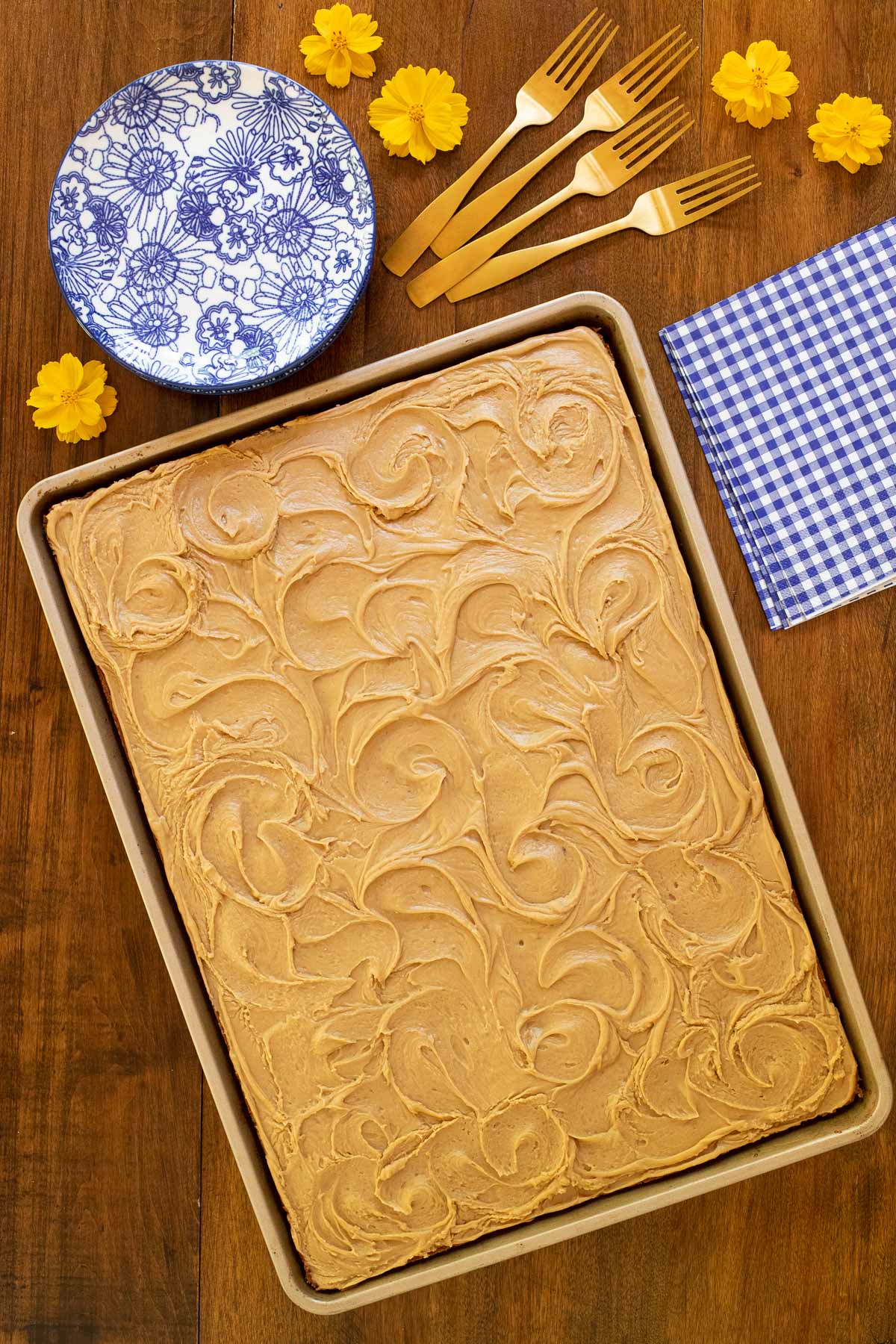 Overhead vertical photo of a Peanut Butter Texas Sheet Cake on a wood table.