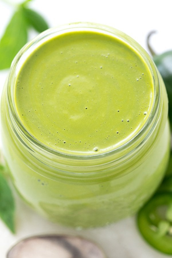 Overhead closeup photo of a jar filled with Peruvian Green Sauce.