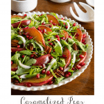Vertical photo of a Caramelized Pear Arugula Salad on a wood table with a word graphic title at the bottom of the photograph.