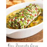 Vertical closeup photo of Herb Marinated Goat Cheese with a word graphic, "Our Favorite Easy Holiday Appetizers, Fun, delicious, and, oh so festive! at the bottom of the photo.