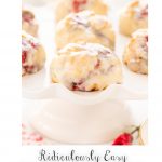 Vertical closeup photo of a batch of Ridiculously Easy Lemon Raspberry Scones on a white pedestal platter.