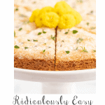 Vertical extreme closeup photo of Lemon Thyme Shortbread garnished with fresh thyme and yellow daisies.
