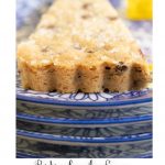 Vertical extreme closeup photo of a Ridiculously Easy Chocolate Chip Shortbread wedge on a blue and white patterned serving plate.