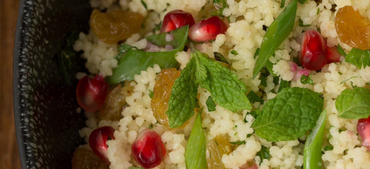 Closeup overhead photo of a bowl Pomegranate Parsley Couscous Salad.