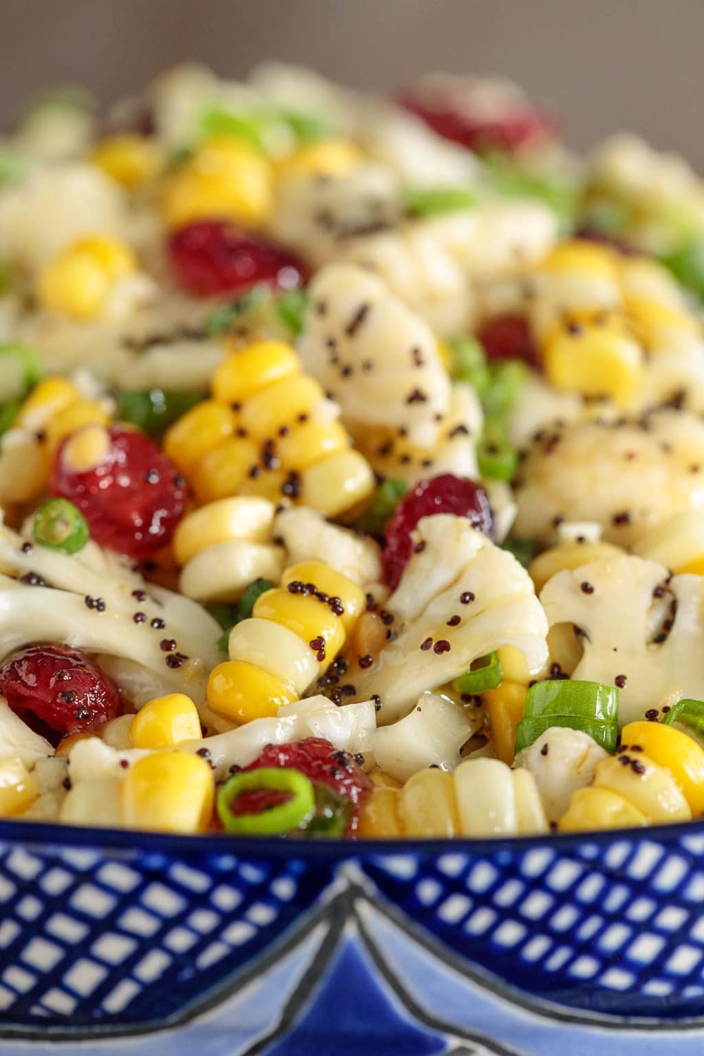 Macro photo of a bowl of Poppyseed Cauliflower and Fresh Corn Salad.