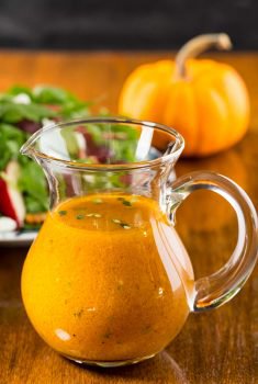 Vertical picture of Pumpkin Maple Vinaigrette in a small glass pitcher