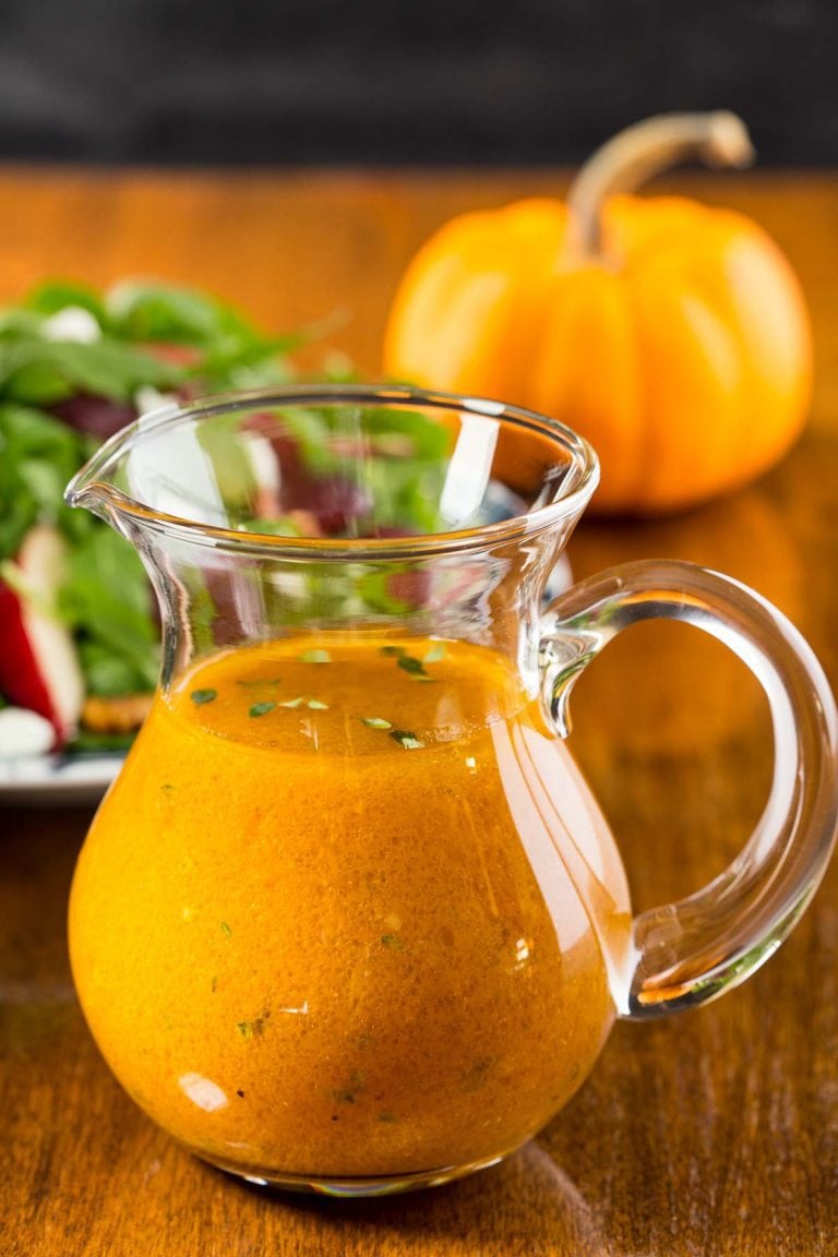 Vertical picture of Pumpkin Maple Vinaigrette in a small glass pitcher