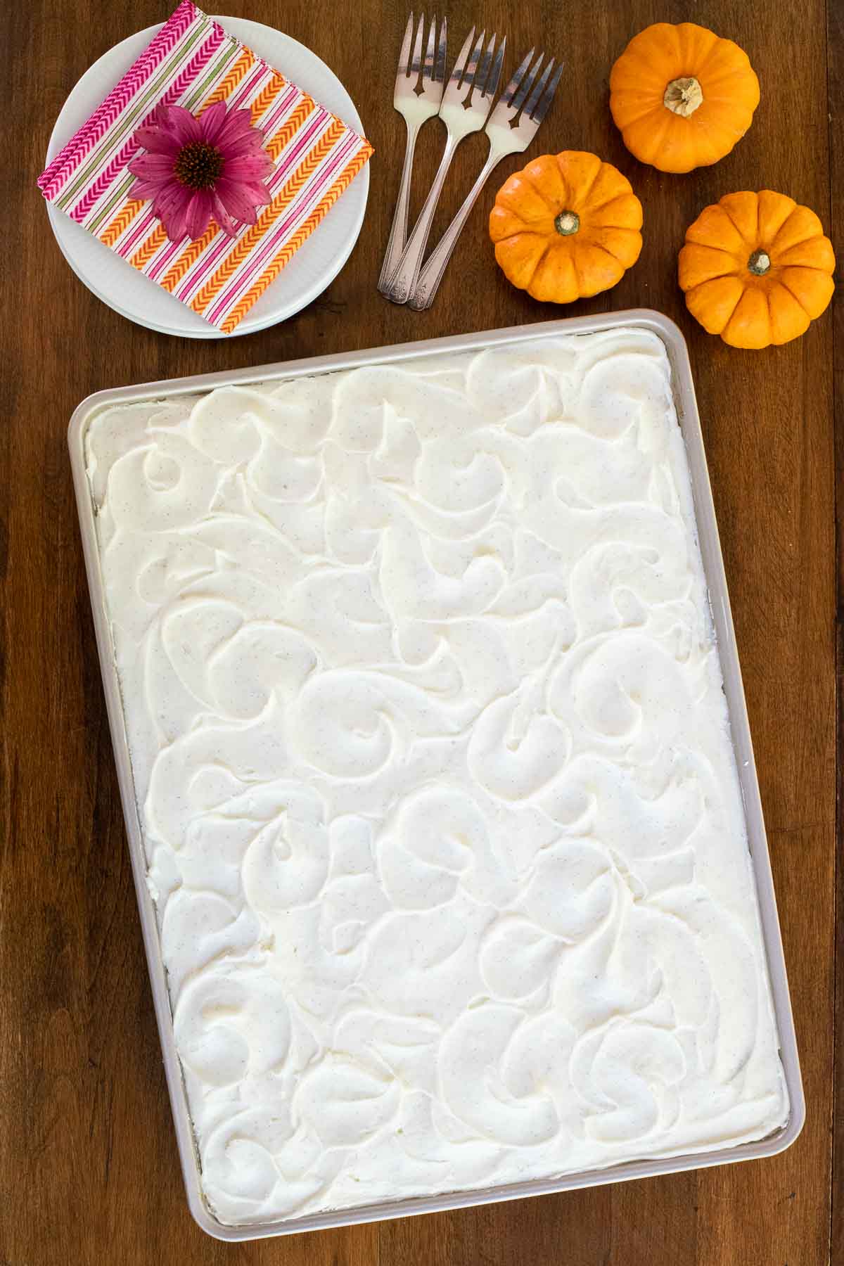 Overhead vertical photo of a One-Bowl, No-Mixer Pumpkin Sheet Cake on a wood table.
