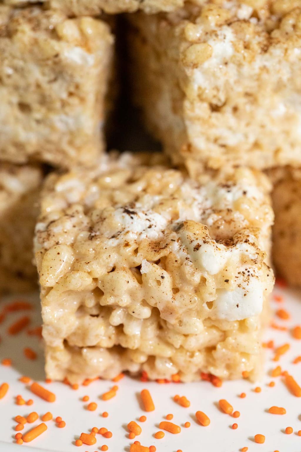 Extreme closeup vertical photo of a stack of Pumpkin Spiced Brown Butter Rice Krispie Treats.