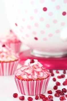 Raspberry Pomegranate Swirl Cupcakes - the most tender, melt-in-you-mouth cupcakes you'll ever meet. And there's a fun swirl of raspberry pomegranate syrup hidden inside!