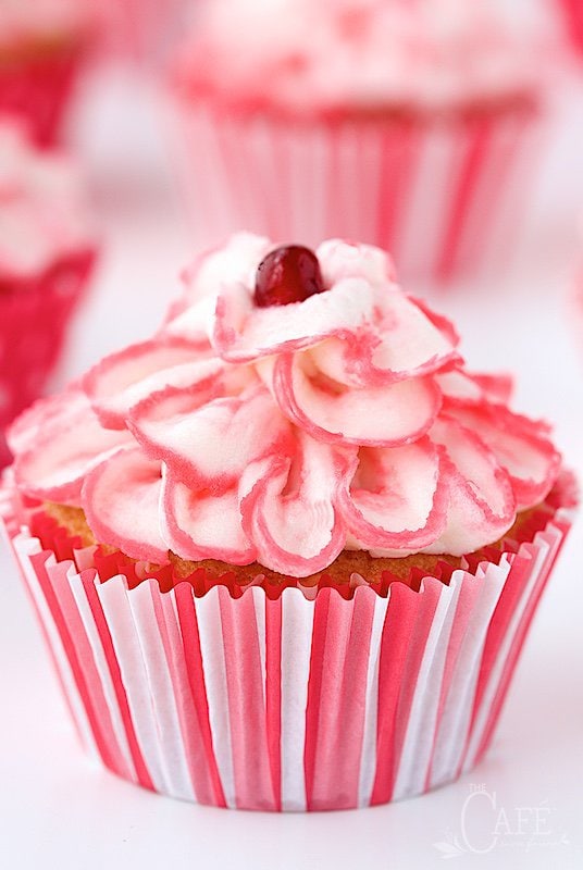 Raspberry Pomegranate Swirl Cupcakes - the most tender, melt-in-you-mouth cupcakes you'll ever meet. And there's a fun swirl of raspberry pomegranate syrup hidden inside!