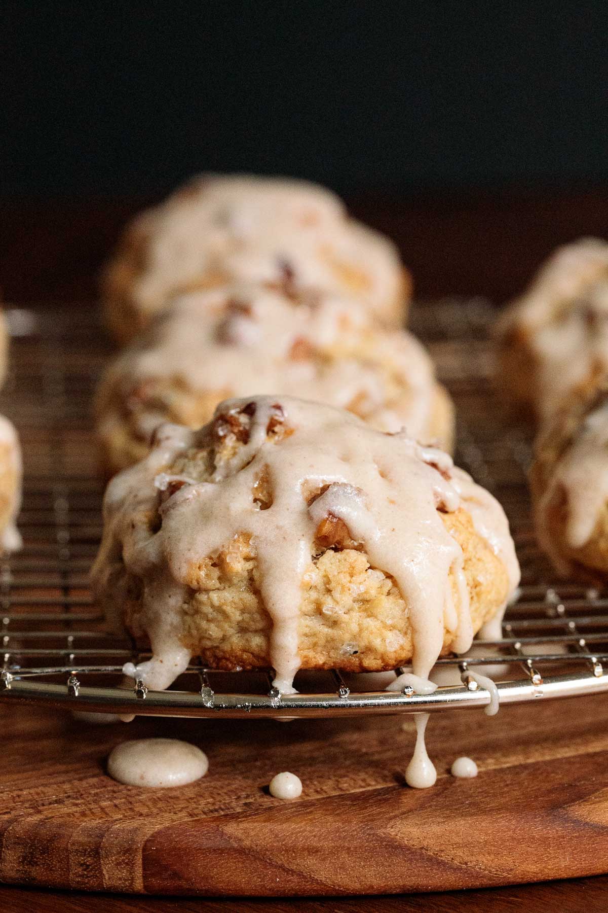 Closeup photo of a Ridiculously Easy Banana Bread Scones with brown butter icing on a wire cooling rack.