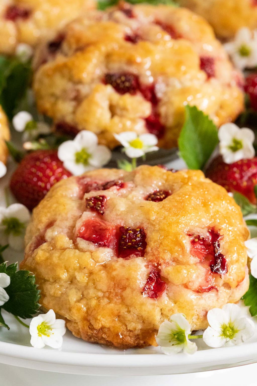 Ultra closeup vertical photo of a platter of Ridiculously Easy Fresh Strawberry Scones.