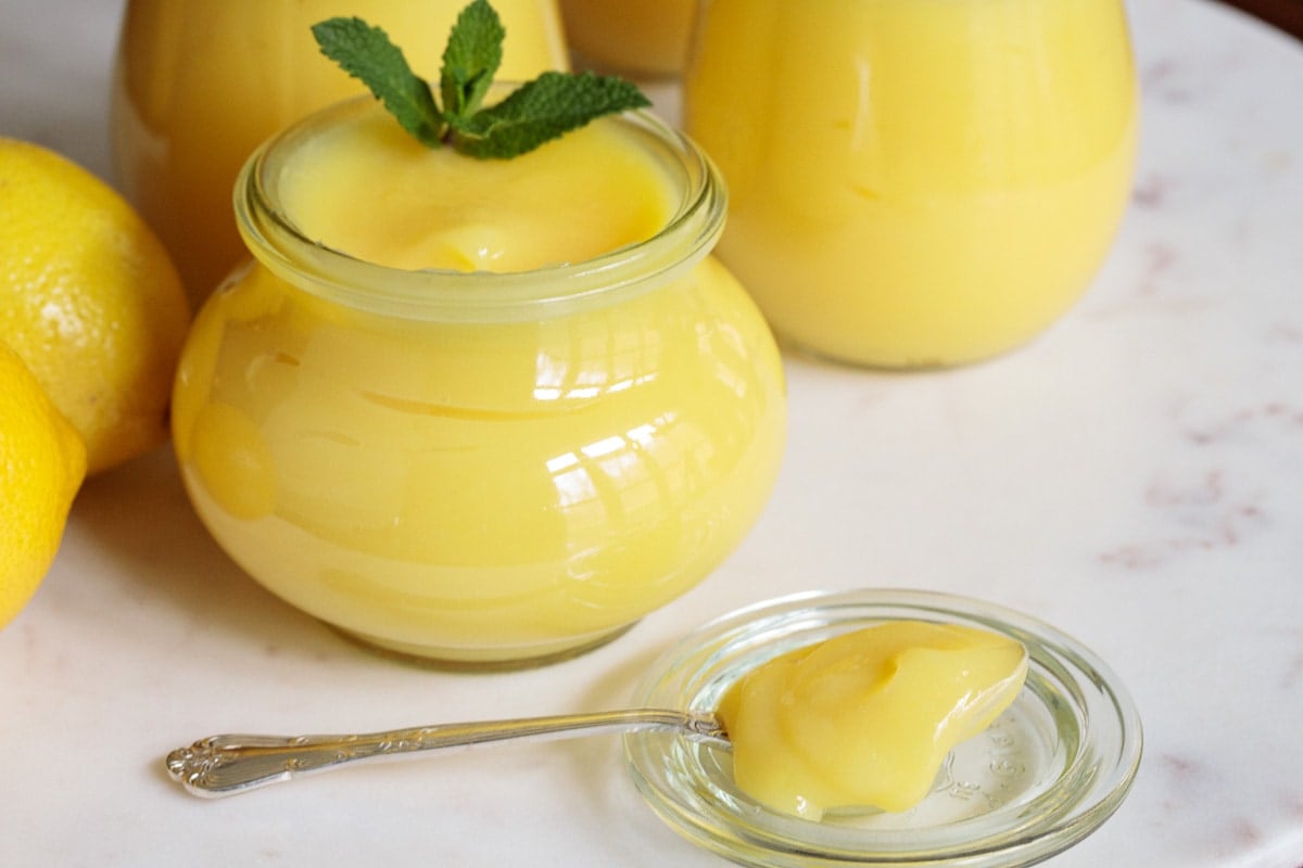 Closeup photo of Weck glass canning jars filled with Microwave Lemon Curd.