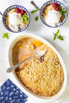 Overhead picture of Easy Peach Crumble scooped into small bowls with ice cream.