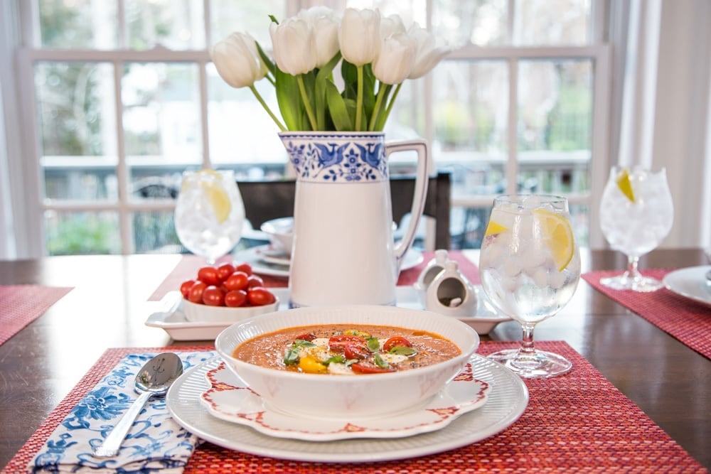 Picture of Roasted Tomato Lentil Soup Caprese on a set table with white tulips 