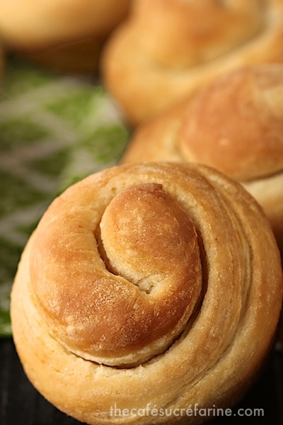 Closeup photo of Buttermilk Honey 5 Minute Dinner Rolls with a green and white napkin in the background.