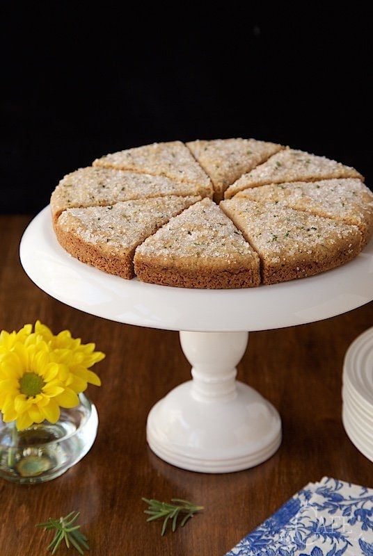 Vertical photo of New York Times Rosemary Shortbread on a white pedestal cake stand. 
