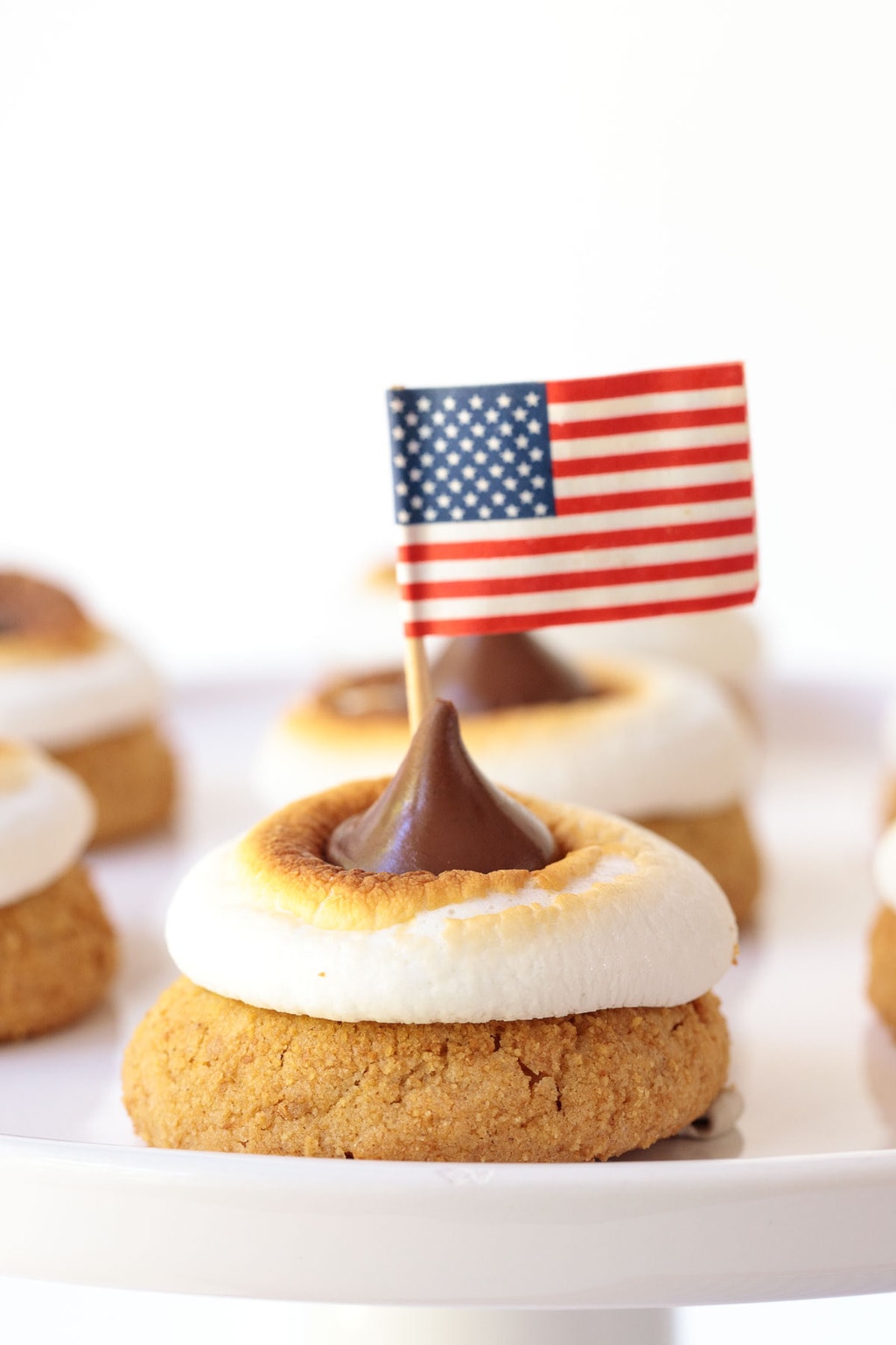 Photo of a serving platter of S'mores Blossom Cookies with American Flags in the center of each.