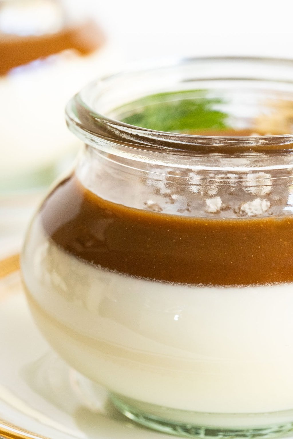 Vertical closeup photo of a glass Weck jar filled with Salted Butterscotch Panna Cotta.