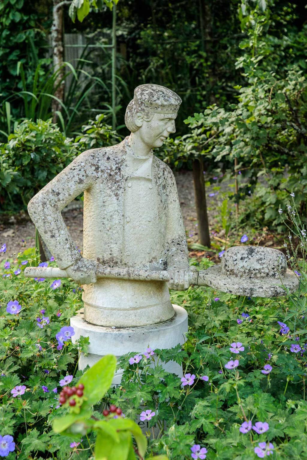 Photo of the baker sculpture in the gardens at Ballymaloe Cookery School.