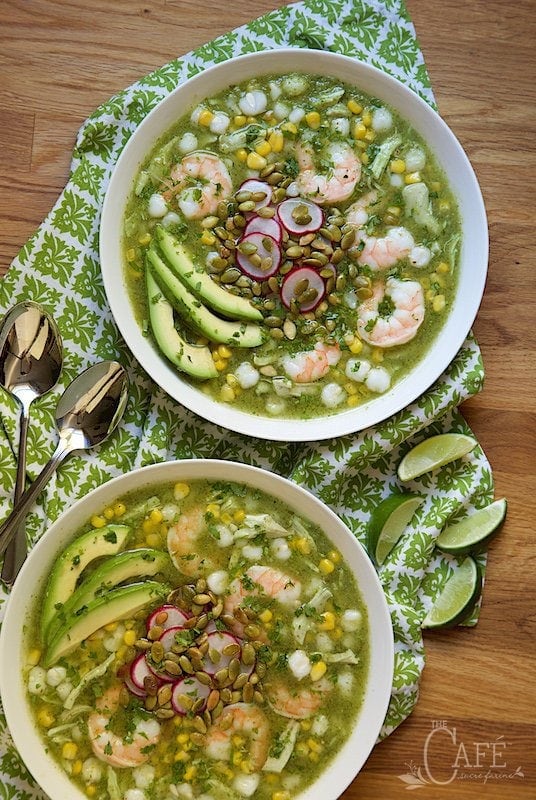 Overhead view of Shrimp and Chicken Pozole on a green cloth on a wooden table