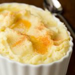 Vertical picture of slow cooker mashed potatoes in a white dish