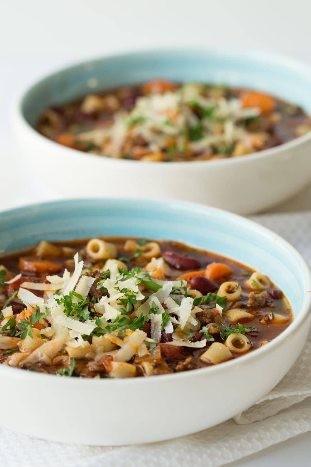 Vertical picture of Slow Cooker Pasta e Fagioli in white bowls