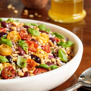 Vertical picture of Slow Roasted Tomato Ancient Grain Salad in a white bowl