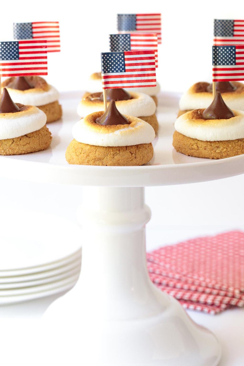 Vertical picture of S'mores Blossom Cookies on a white cakestand