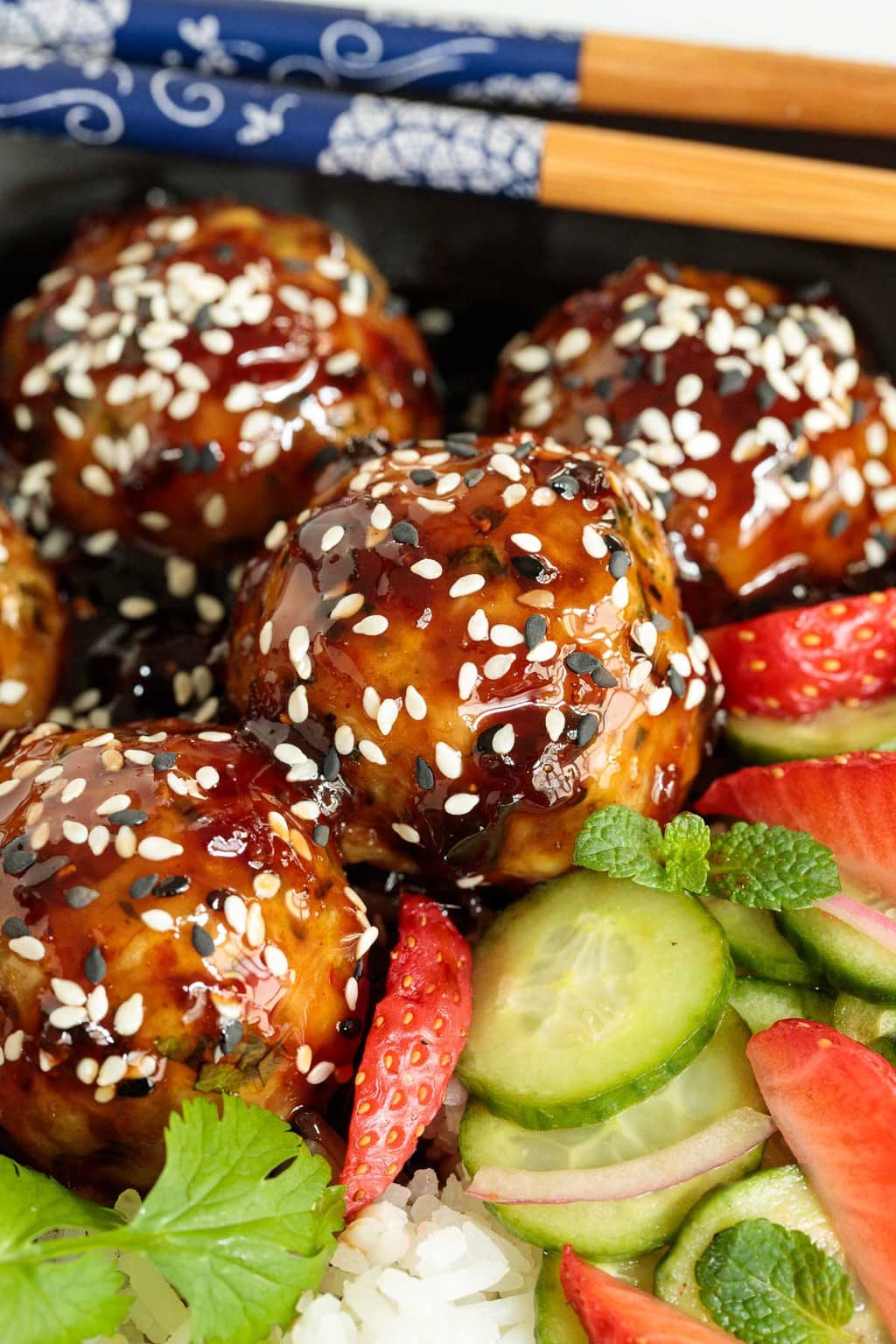 Ultra closeup photo of a dish of Strawberry Balsamic Chicken Meatball Rice Bowls.