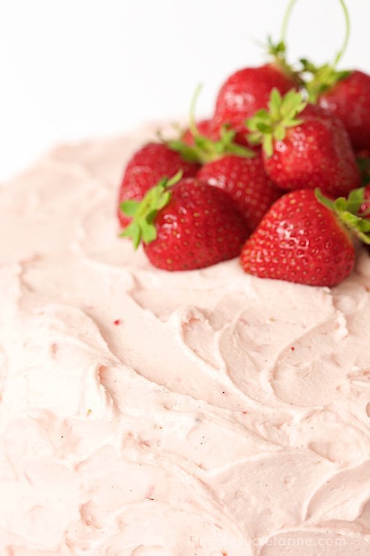 Strawberry Layer Cake - with layers of tender, moist yellow cake sandwiched between a double dose of strawberries - fresh strawberry buttercream and strawberry jam, this cake is the kind of confection that dreams are made of! thecafesucrefarine.com