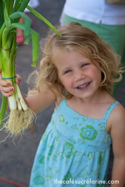 Lilly helping to pick out vegetables for supper at a local farmer's market.