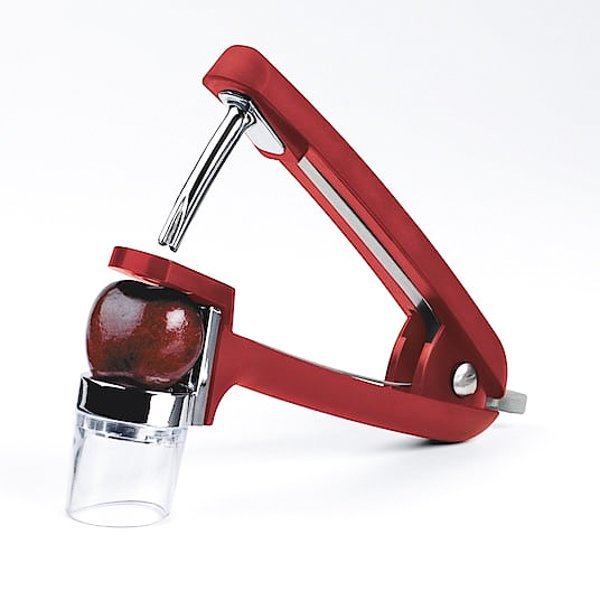 Photo of a hand cherry pitting tool.