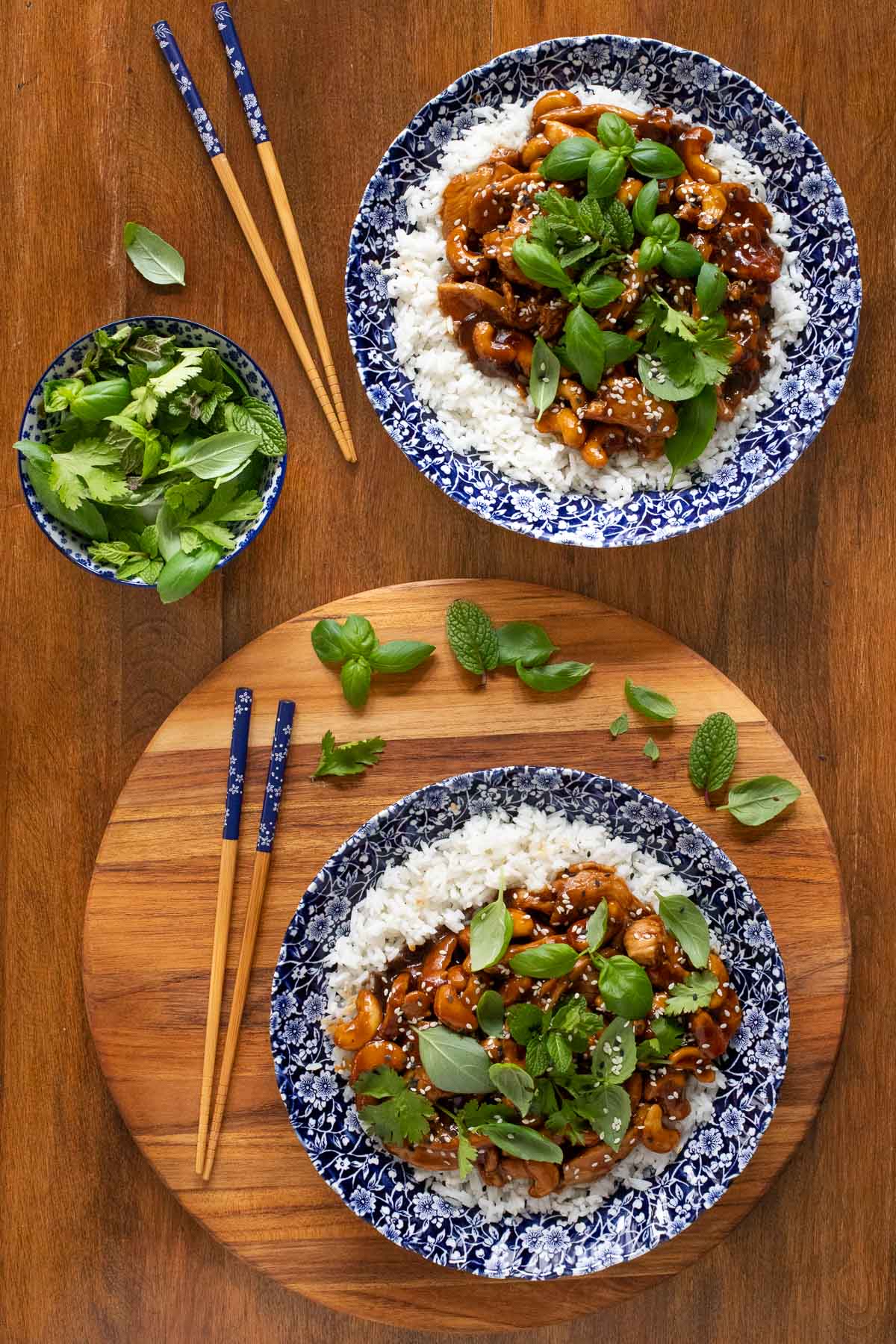Overhead vertical photo of Sweet and Spicy Hoisin Cashew Chicken and rice in blue and white patterned serving bowls.